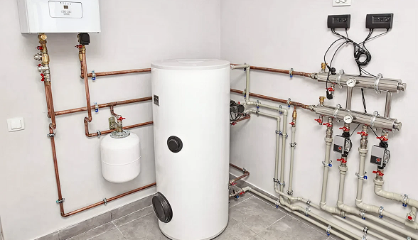 A Bosanac boiler protection system shows connected tanks, valves, gauges, and pipes installed neatly in a tiled utility room. A Bosanac boiler protection system shows connected tanks, valves, gauges, and pipes installed neatly in a tiled utility room.