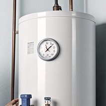 A Bosanac water heater system with a temperature gauge mounted on the front and connected copper pipes. A Bosanac water heater system with a temperature gauge mounted on the front and connected copper pipes.